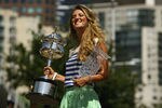 MELBOURNE, AUSTRALIA - JANUARY 29:  Victoria Azarenka of Belarus poses with the Daphne Akhurst Trophy and the World number One Trophy after winning the 2012 Women's Australian Open final, along the Yarra River on January 29, 2012 in Melbourne, Australia.  (Photo by Robert Prezioso/Getty Images)