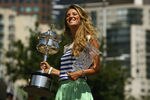 MELBOURNE, AUSTRALIA - JANUARY 29:  Victoria Azarenka of Belarus poses with the Daphne Akhurst Trophy and the World number One Trophy after winning the 2012 Women's Australian Open final, along the Yarra River on January 29, 2012 in Melbourne, Australia.  (Photo by Robert Prezioso/Getty Images)