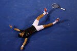 MELBOURNE, AUSTRALIA - JANUARY 29:  Novak Djokovic of Serbia falls to the floor exhausted after a 31 shot rally in his men's final match against Rafael Nadal of Spain during day fourteen of the 2012 Australian Open at Melbourne Park on January 29, 2012 in Melbourne, Australia.  (Photo by Cameron Spencer/Getty Images)
