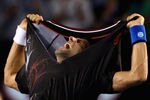 MELBOURNE, AUSTRALIA - JANUARY 29:  Novak Djokovic of Serbia rips his shirt off after winning championship point in his men's final match against Rafael Nadal of Spain during day fourteen of the 2012 Australian Open at Melbourne Park on January 29, 2012 in Melbourne, Australia.  (Photo by Ryan Pierse-Pool/Getty Images)