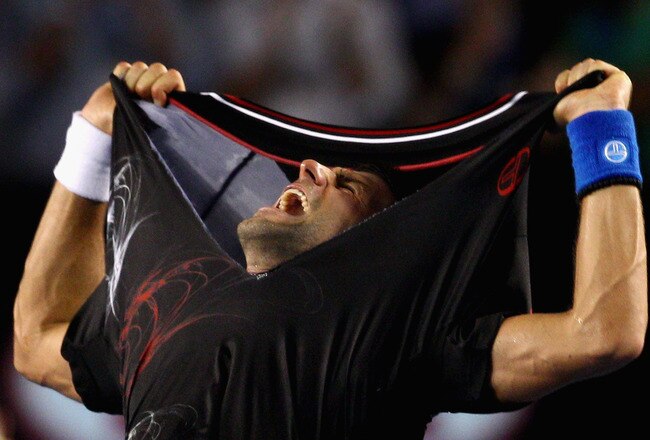 MELBOURNE, AUSTRALIA - JANUARY 29:  Novak Djokovic of Serbia rips his shirt off after winning championship point in his men's final match against Rafael Nadal of Spain during day fourteen of the 2012 Australian Open at Melbourne Park on January 29, 2012 in Melbourne, Australia.  (Photo by Ryan Pierse-Pool/Getty Images)