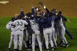 26 Oct 2000:  The New York Yankees mob pitcher Mariano Rivera after the last out is made against the New York Mets in Game 5 of the World Series at Shea Stadium in Flushing, New York. DIGITAL IMAGE> Mandatory Credit: Matthew Stockman/ALLSPORT