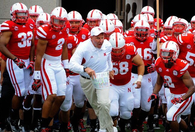 LINCOLN, NE - SEPTEMBER 3: Head Coach Bo Pelini leads his Nebraska Cornhuskers onto the field against the Chattanooga Mocs before their game at Memorial Stadium September 3, 2011 in Lincoln, Nebraska. Nebraska won 40-7. (Photo by Eric Francis/Getty Images)