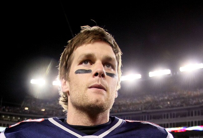 FOXBORO, MA - JANUARY 22:  Tom Brady #12 of the New England Patriots walks off the field after defeating the Baltimore Ravens in the AFC Championship Game at Gillette Stadium on January 22, 2012 in Foxboro, Massachusetts. The New England Patriots defeated the Baltimore Ravens 20-23.  (Photo by Elsa/Getty Images)