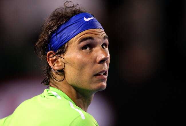 MELBOURNE, AUSTRALIA - JANUARY 29:  Rafael Nadal of Spain looks on between games in his men's final match against Novak Djokovic of Serbia during day fourteen of the 2012 Australian Open at Melbourne Park on January 29, 2012 in Melbourne, Australia.  (Photo by Scott Barbour/Getty Images)