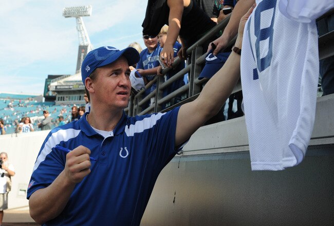 JACKSONVILLE, FL - JANUARY 01: Quarterback Peyton Manning #18 of the Indianapolis Colts signs autographs before the kickoff against the Jacksonville Jaguars January 1 at EverBank Field in Jacksonville, Florida.  (Photo by Al Messerschmidt/Getty Images)