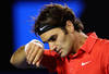 MELBOURNE, AUSTRALIA - JANUARY 26:  Roger Federer of Switzerland wipes his face n in his semifinal match against Rafael Nadal of Spain during day eleven of the 2012 Australian Open at Melbourne Park on January 26, 2012 in Melbourne, Australia.  (Photo by Cameron Spencer/Getty Images)