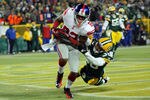 GREEN BAY, WI - JANUARY 15:  Mario Manningham #82 of the New York Giants catches a four yard touchdown pass in the fourth quarter against Tramon Williams #38 of the Green Bay Packers during their NFC Divisional playoff game at Lambeau Field on January 15, 2012 in Green Bay, Wisconsin.  (Photo by Jonathan Daniel/Getty Images)