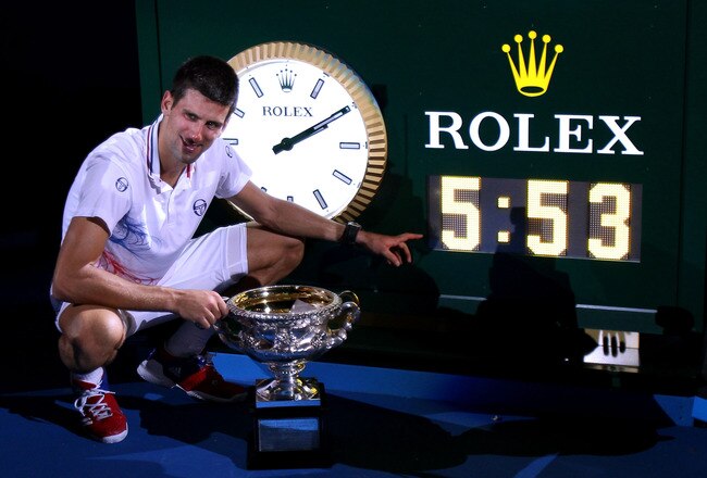 MELBOURNE, AUSTRALIA - JANUARY 29:  Novak Djokovic of Serbia poses with the Norman Brookes Challenge Cup and the clock after winning championship point and playing in the longest grand slam final ever in his men's final match against Rafael Nadal of Spain during day fourteen of the 2012 Australian Open at Melbourne Park on January 29, 2012 in Melbourne, Australia.  (Photo by Scott Barbour/Getty Images)