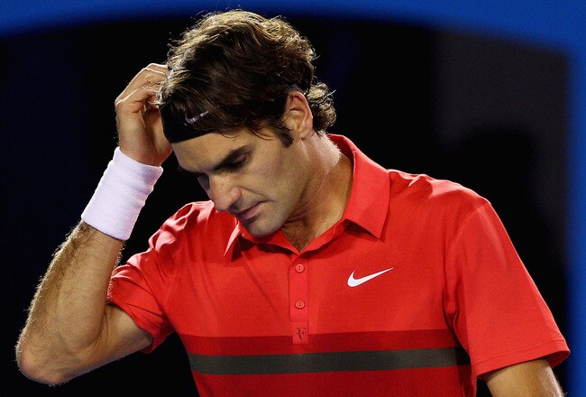 MELBOURNE, AUSTRALIA - JANUARY 26:  Roger Federer of Switzerland wipes his face n in his semifinal match against Rafael Nadal of Spain during day eleven of the 2012 Australian Open at Melbourne Park on January 26, 2012 in Melbourne, Australia.  (Photo by Cameron Spencer/Getty Images)
