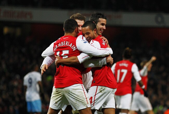 LONDON, ENGLAND - JANUARY 29:  Theo Walcott of Arsenal (14) celebrates with team mates as he scores their second gaol during the FA Cup with Budweiser Fourth Round match between Arsenal and Aston Villa at Emirates Stadium on January 29, 2012 in London, England.  (Photo by Paul Gilham/Getty Images)