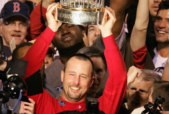 ST LOUIS - OCTOBER 27:  Tim Wakefield #49 of the Boston Red Sox celebrates with the trophy after defeating the St. Louis Cardinals 3-0 in game four of the World Series on October 27, 2004 at Busch Stadium in St. Louis, Missouri. (Photo by Al Bello/Getty Images)