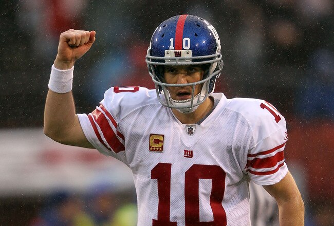 SAN FRANCISCO, CA - JANUARY 22:  Eli Manning #10 of the New York Giants celebrates after he threw a 6-yard touchdown pass to Bear Pascoe #86 against the San Francisco 49ers in the second quarter during the NFC Championship Game at Candlestick Park on January 22, 2012 in San Francisco, California.  (Photo by Jamie Squire/Getty Images)