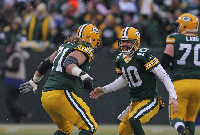 GREEN BAY, WI - JANUARY 01:  Matt Flynn #10 of the Green Bay Packers celebrates a touchdown pass with Josh Sitton #71 against the Detroit Lions at Lambeau Field on January 1, 2012 in Green Bay, Wisconsin. The Packers defeated the Lions 45-41.  (Photo by Jonathan Daniel/Getty Images)