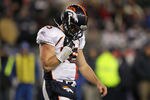 FOXBORO, MA - JANUARY 14:  Tim Tebow #15 of the Denver Broncos walks back to the bench after he was sacked in the second half by the New England Patriots defense during their AFC Divisional Playoff Game at Gillette Stadium on January 14, 2012 in Foxboro, Massachusetts.  (Photo by Jim Rogash/Getty Images)