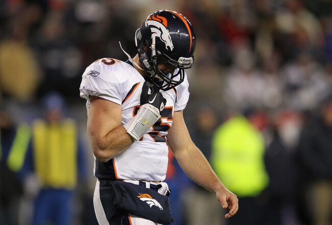 FOXBORO, MA - JANUARY 14:  Tim Tebow #15 of the Denver Broncos walks back to the bench after he was sacked in the second half by the New England Patriots defense during their AFC Divisional Playoff Game at Gillette Stadium on January 14, 2012 in Foxboro, Massachusetts.  (Photo by Jim Rogash/Getty Images)