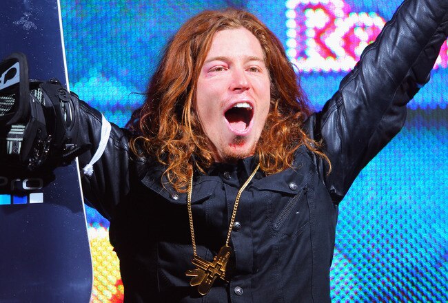 ASPEN, CO - JANUARY 29:  Shaun White celebrates as he takes the podium for the goal medal in the men's snowboard superpipe final during Winter X Games 2012 at Buttermilk Mountain on January 29, 2012 in Aspen, Colorado. White earned his fifth consecutive gold medal in the event and scored a perfect 100 points on his final run.  (Photo by Doug Pensinger/Getty Images)