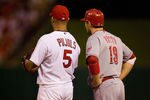 ST. LOUIS - SEPTEMBER 3: Albert Pujols #5 of the St. Louis Cardinals and Joey Votto #19 of the Cincinnati Reds stand on first base at Busch Stadium on September 3, 2010 in St. Louis, Missouri.  The Cardinals beat the Reds 3-2.  (Photo by Dilip Vishwanat/Getty Images)