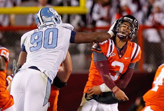 BLACKSBURG, VA - NOVEMBER 17: Logan Thomas #3 of the Virginia Tech Hokies is struck in the head after throwing the ball by Quinton Coples #90 of the North Carolina Tar Heels at Lane Stadium on November 17, 2011 in Blacksburg, Virginia. (Photo by Geoff Burke/Getty Images)