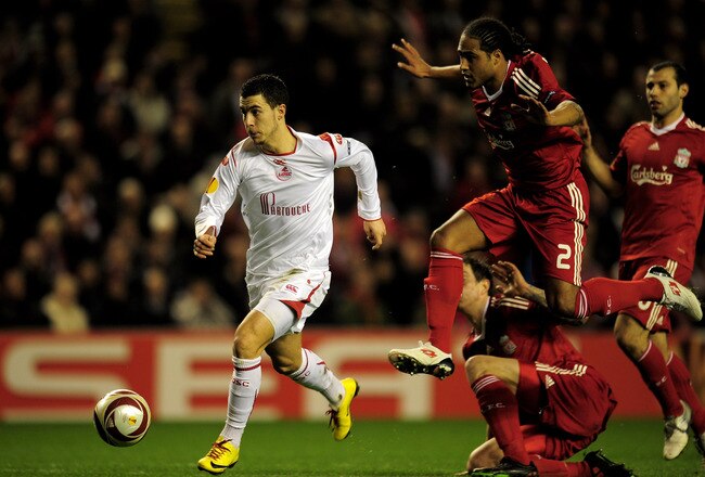 LIVERPOOL, ENGLAND - MARCH 18:  Eden Hazard of Lille breaks clear of the challenge of Glen Johnson of Liverpool during the UEFA Europa League Round of 16, second leg match at Anfield on March 18, 2010 in Liverpool, England.  (Photo by Shaun Botterill/Getty Images)