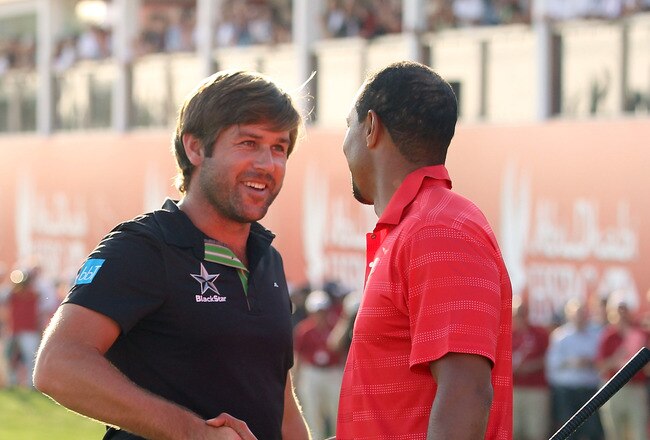 ABU DHABI, UNITED ARAB EMIRATES - JANUARY 29:  Robert Rock of England (L) is congratulated by Tiger Woods of the USA after winning The Abu Dhabi HSBC Golf Championship at Abu Dhabi Golf Club on January 29, 2012 in Abu Dhabi, United Arab Emirates.  (Photo by Andrew Redington/Getty Images)