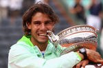 PARIS - JUNE 06:  Rafael Nadal of Spain celebrates with the trophy after winning the men's singles final match between Rafael Nadal of Spain and Robin Soderling of Sweden on day fifteen of the French Open at Roland Garros on June 6, 2010 in Paris, France.  (Photo by Julian Finney/Getty Images)