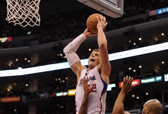LOS ANGELES, CA - JANUARY 14:  Blake Griffin #32 of the Los Angeles Clippers is fouled as he attempts a dunk on Matt Barnes #9 and Derek Fisher #2 of the Los Angeles Lakers during a 102-94 Clipper win at Staples Center on January 14, 2012 in Los Angeles, California.  NOTE TO USER: User expressly acknowledges and agrees that, by downloading and/or using this Photograph, user is consenting to the terms and conditions of the Getty Images License Agreement.  (Photo by Harry How/Getty Images)