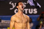 MELBOURNE, AUSTRALIA - JANUARY 29:  Novak Djokovic of Serbia rips his shirt off after winning championship point in his men's final match against Rafael Nadal of Spain during day fourteen of the 2012 Australian Open at Melbourne Park on January 29, 2012 in Melbourne, Australia.  (Photo by Mark Kolbe/Getty Images)