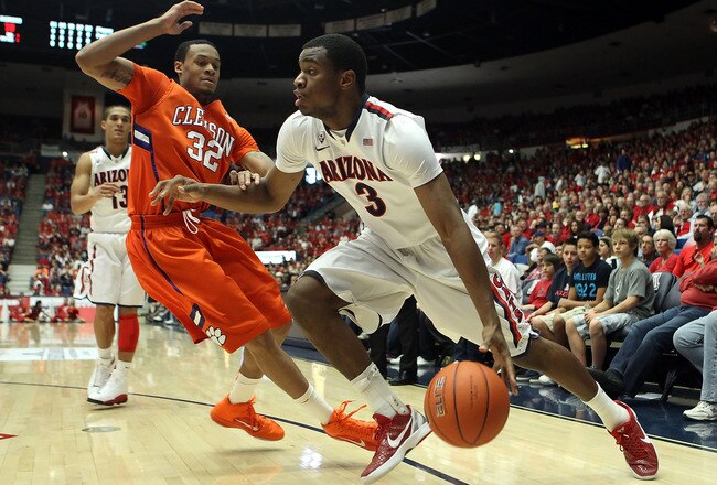 TUCSON, AZ - DECEMBER 10:  Kevin Parrom #3 of the Arizona Wildcats handles the ball under pressure from K.J. McDaniels #32 of the Clemson Tigers during the first half of the college basketball game at McKale Center on December 10, 2011 in Tucson, Arizona. The Wildcats defeated the Tigers 63-47.  (Photo by Christian Petersen/Getty Images)