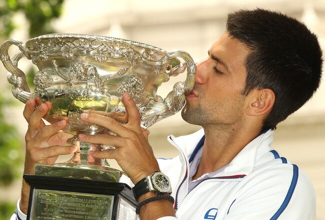 MELBOURNE, AUSTRALIA - JANUARY 30:  Novak Djokovic of Serbia poses with the Norman Brookes Challenge Cup after winning the 2012 men's Australian Open, at Carlton Gardens on January 30, 2012 in Melbourne, Australia.  (Photo by Lucas Dawson/Getty Images)