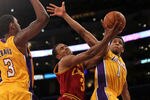 LOS ANGELES, CA - JANUARY 13:  Ramon Sessions #3 of the Cleveland Cavaliers goes up for a shot between Darius Morris #1 and Devin Ebanks #3 of the Los Angeles Lakers at Staples Center on January 13, 2012 in Los Angeles, California.  The Lakers won 97-92.  NOTE TO USER: User expressly acknowledges and agrees that, by downloading and or using this photograph, User is consenting to the terms and conditions of the Getty Images License Agreement.  (Photo by Stephen Dunn/Getty Images)