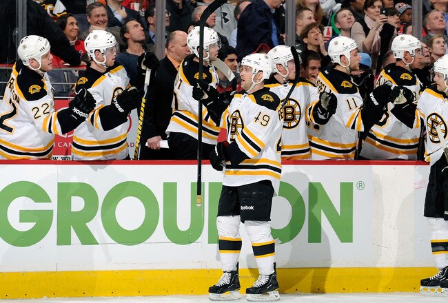 WASHINGTON, DC - JANUARY 24:  Rich Peverley #49 of the Boston Bruins celebrates with teammates after scoring in the first period against the Washington Capitals at the Verizon Center on January 24, 2012 in Washington, DC.  (Photo by Greg Fiume/Getty Images)
