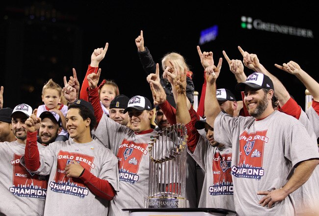 ST LOUIS, MO - OCTOBER 28: Jon Jay #19, Allen Craig #21 and Lance Berkman #12 of the St. Louis Cardinals celebrate with the World Series trophy after defeating the Texas Rangers 6-2 to win the World Series in Game Seven of the MLB World Series at Busch Stadium on October 28, 2011 in St Louis, Missouri.  (Photo by Ezra Shaw/Getty Images)