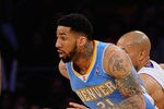 LOS ANGELES, CA - APRIL 03: Wilson Chandler #21 of the Denver Nuggets  drives past Derek Fisher #2 of the Los Angeles Lakers during the game at Staples Center on April 3, 2011 in Los Angeles, California. NOTE TO USER: User expressly acknowledges and agrees that, by downloading and or using this photograph, User is consenting to the terms and conditions of the Getty Images License Agreement.  (Photo by Kevork Djansezian/Getty Images)