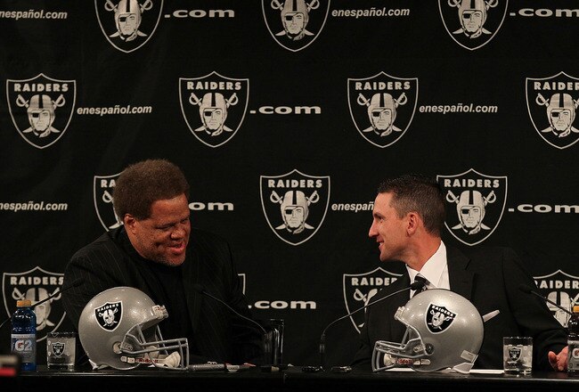 ALAMEDA, CA - JANUARY 30:  New Oakland Raiders head coach Dennis  Allen (R) talks to Raiders general manager Reggie McKenzie (L) looks on during a press conference on January 30, 2012 in Alameda, California. Dennis Allen was introduced as the new coach of the Oakland Raiders, replacing Hue Jackson who was fired after one season.  (Photo by Justin Sullivan/Getty Images)