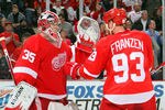 DETROIT, MI - JANUARY 23:  Johan Franzen #93 of the Detroit Red Wings celebrates a win over the St. Louis Blues with teammate Jimmy Howard #35 during their NHL game at Joe Louis Arena on January 23, 2012 in Detroit, Michigan.  (Photo by Dave Sandford/Getty Images)
