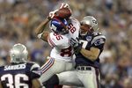 GLENDALE, AZ - FEBRUARY 03:  David Tyree #85 of the New York Giants catches a 32-yard pass from Eli Manning #10 against Rodney Harrison #37 and James Sanders #36 of the New England Patriots attempts to knock it out in the fourth quarter of Super Bowl XLII on February 3, 2008 at the University of Phoenix Stadium in Glendale, Arizona. The Giants won 17-14. (Photo by Andy Lyons/Getty Images)