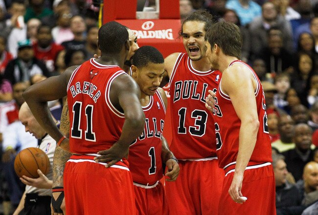 WASHINGTON, DC - JANUARY 30: Joakim Noah #13 of the Chicago Bulls talks with teammates Ronnie Brewer #11, Derrick Rose #1 and Kyle Korver #26 during the second half against the Washington Wizards at Verizon Center on January 30, 2012 in Washington, DC. NOTE TO USER: User expressly acknowledges and agrees that, by downloading and or using this photograph, User is consenting to the terms and conditions of the Getty Images License Agreement.  (Photo by Rob Carr/Getty Images)
