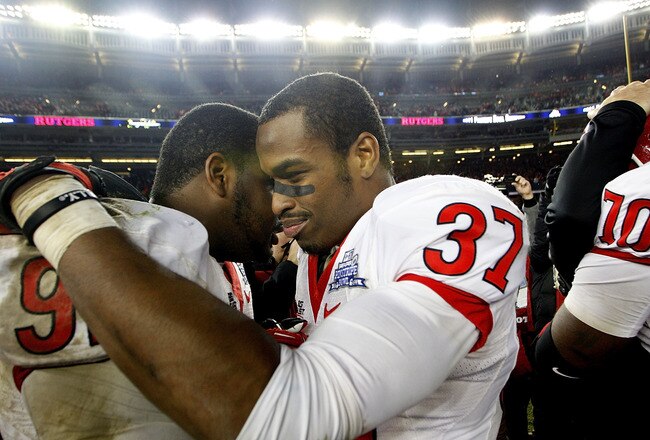 NEW YORK - DECEMBER 30:  (L-R) Jamil Merrell #92 and Jamal Merrell #37 of the Rutgers Scarlet Knights celebrate a win over the Iowa State Cyclones in the New Era Pinstripe Bowl at Yankee Stadium on December 30, 2011 in the Bronx Borough of New York City.  (Photo by Jeff Zelevansky/Getty Images)