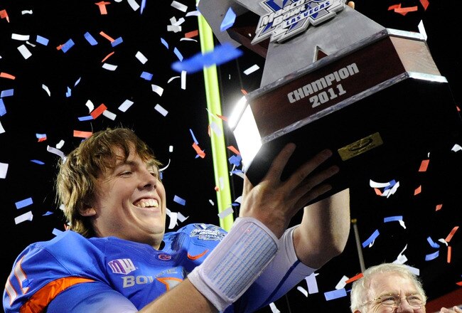 LAS VEGAS, NV - DECEMBER 22:  Quarterback Kellen Moore #11 of the Boise State Broncos holds up the trophy after defeating the Arizona State Sun Devils 56-24 in the MAACO Bowl Las Vegas at Sam Boyd Stadium December 22, 2011 in Las Vegas, Nevada.  (Photo by Ethan Miller/Getty Images)