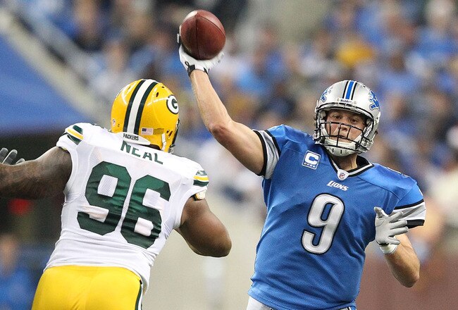 DETROIT, MI - NOVEMBER 24: Matthew Stafford #9 of the Detroit Lions drops back to pass during the first quarter of the game as Mike Neal #96 of the Green Bay Packers puts on the rush during the game at Ford Field on November 24, 2011 in Detroit, Michigan. (Photo by Leon Halip/Getty Images)