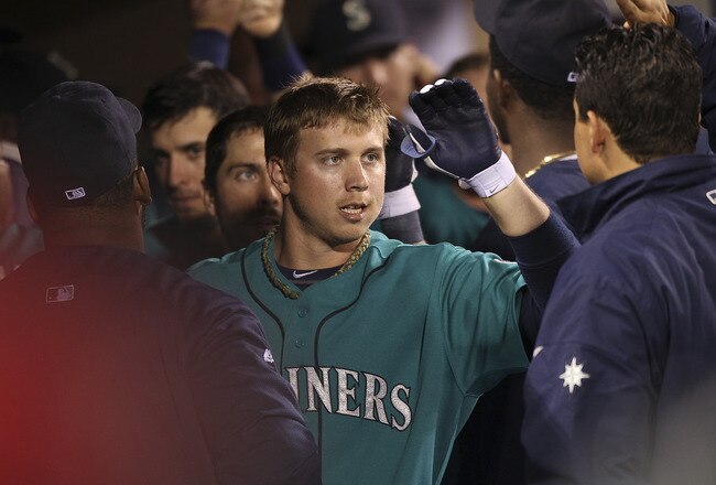 SEATTLE - SEPTEMBER 26:  Justin Smoak #17 of the Seattle Mariners is congratulated by teammates after hitting a three-run homer in the sixth inning against the Oakland Athletics at Safeco Field on September 26, 2011 in Seattle, Washington. (Photo by Otto Greule Jr/Getty Images)