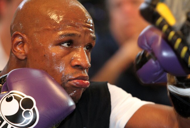 LAS VEGAS, NV - SEPTEMBER 06:  Floyd Mayweather hits the pads in the ring during his workout training session at his gym on September 6, 2011 in Las Vegas, Nevada.  (Photo by Jeff Bottari/Getty Images)