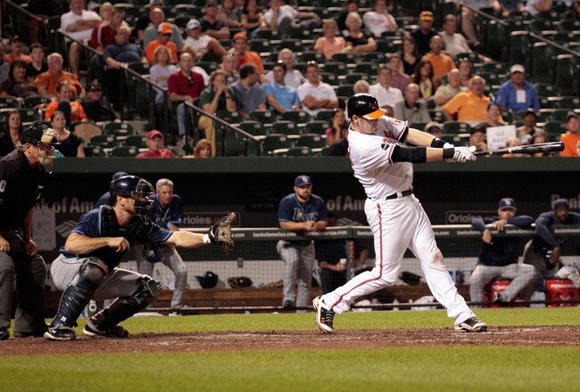 BALTIMORE, MD - SEPTEMBER 13:  Catcher John Jaso #28 of the Tampa Bay Rays and umpire Tom Hallion look on as Matt Wieters #32 of the Baltimore Orioles follows his two RBI go ahead home run during the eighth inning at Oriole Park at Camden Yards on September 13, 2011 in Baltimore, Maryland. The Orioles defeated the Rays 4-2.  (Photo by Rob Carr/Getty Images)