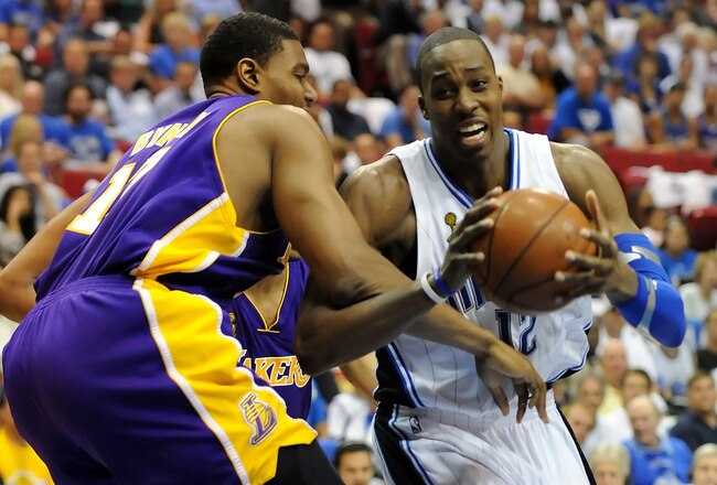 ORLANDO, FL - JUNE 14:  Dwight Howard #12 of the Orlando Magic drives on Andrew Bynum #17 of the Los Angeles Lakers in the third quarter of Game Five of the 2009 NBA Finals on June 14, 2009 at Amway Arena in Orlando, Florida.  NOTE TO USER:  User expressly acknowledges and agrees that, by downloading and or using this photograph, User is consenting to the terms and conditions of the Getty Images License Agreement.  (Photo by Ronald Martinez/Getty Images)