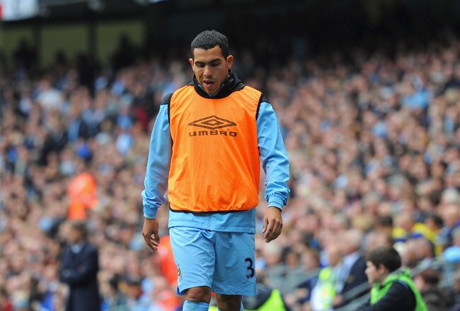 MANCHESTER, ENGLAND - SEPTEMBER 24:  Carlos Tevez of Manchester City looks on from the sidelines during the Barclays Premier League match between Manchester City and Everton at the Etihad Stadium on September 24, 2011 in Manchester, England.  (Photo by Michael Regan/Getty Images)