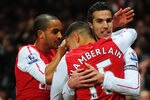 LONDON, ENGLAND - JANUARY 22:  Robin van Persie of Arsenal (R) celebrates with Theo Walcott (L)and Alex Oxlade-Chamberlain (C) as he scores their first goal during the Barclays Premier League match between Arsenal and Manchester United at Emirates Stadium on January 22, 2012 in London, England.  (Photo by Mike Hewitt/Getty Images)