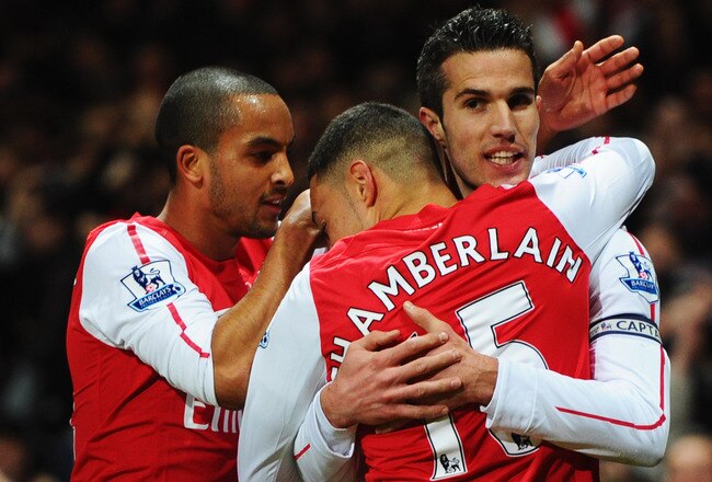 LONDON, ENGLAND - JANUARY 22:  Robin van Persie of Arsenal (R) celebrates with Theo Walcott (L)and Alex Oxlade-Chamberlain (C) as he scores their first goal during the Barclays Premier League match between Arsenal and Manchester United at Emirates Stadium on January 22, 2012 in London, England.  (Photo by Mike Hewitt/Getty Images)