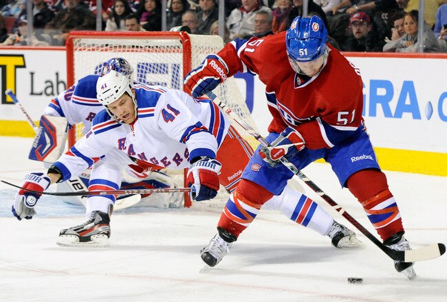 MONTREAL, CANADA - JANUARY 15:  David Desharnais #51 of the Montreal Canadiens stick handles the puck in front of Stu Bickel #41 of the New York Rangers during the NHL game at the Bell Centre on January 15, 2012 in Montreal, Quebec, Canada.  (Photo by Richard Wolowicz/Getty Images)