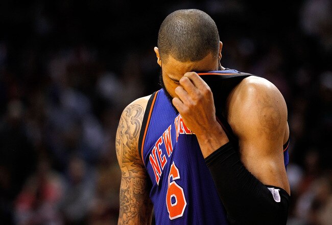 MIAMI, FL - JANUARY 27: Tyson Chandler #6 of the New York Knicks wipes his face during a game against the Miami Heat at American Airlines Arena on January 27, 2012 in Miami, Florida. NOTE TO USER: User expressly acknowledges and agrees that, by downloading and/or using this Photograph, User is consenting to the terms and conditions of the Getty Images License Agreement.  (Photo by Mike Ehrmann/Getty Images)